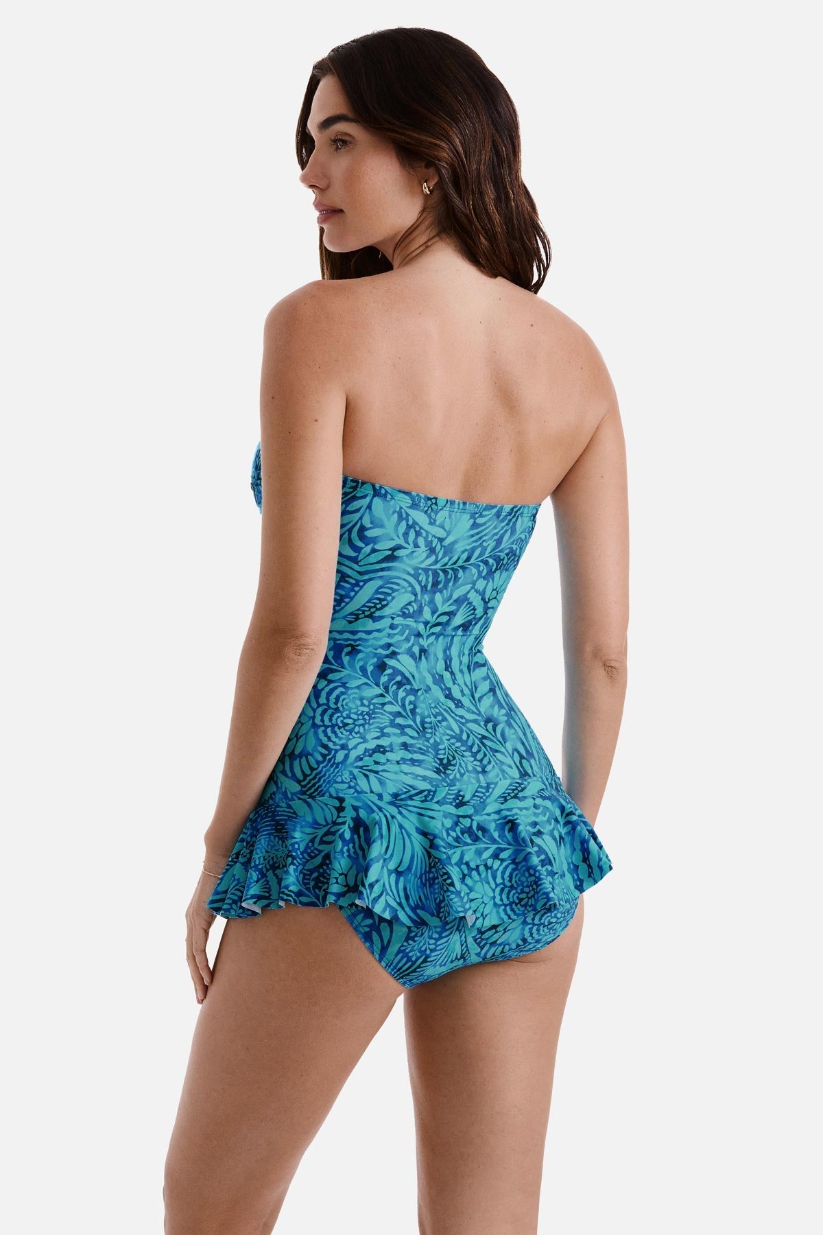 Woman turned left wearing a blue abstract printed skirted one-piece swimsuit