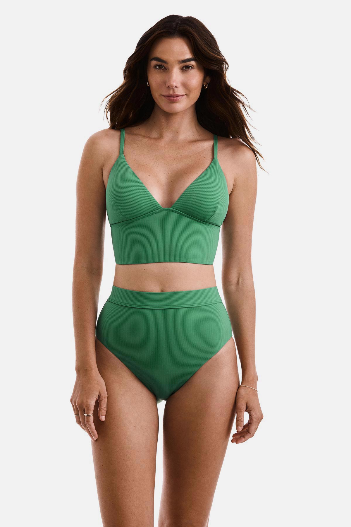 Woman wearing a green ribbed midkini bralette swim top with matching swim bottoms
