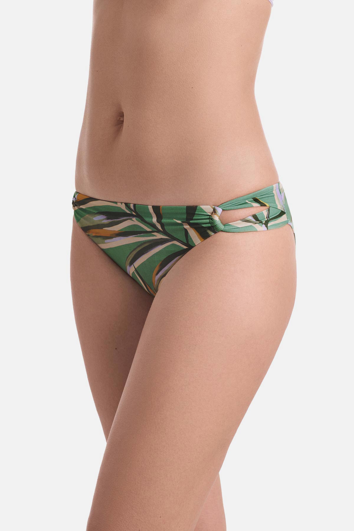 Side view of multicolored leaf printed swim bottoms with side cutouts 