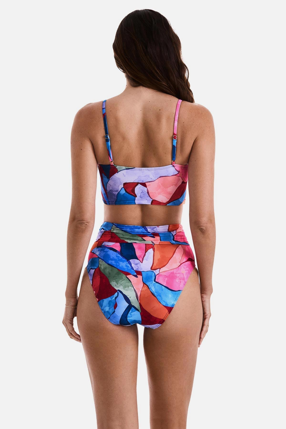 Woman faced away wearing a multicolored abstract printed midkini swim top with matching swim bottoms