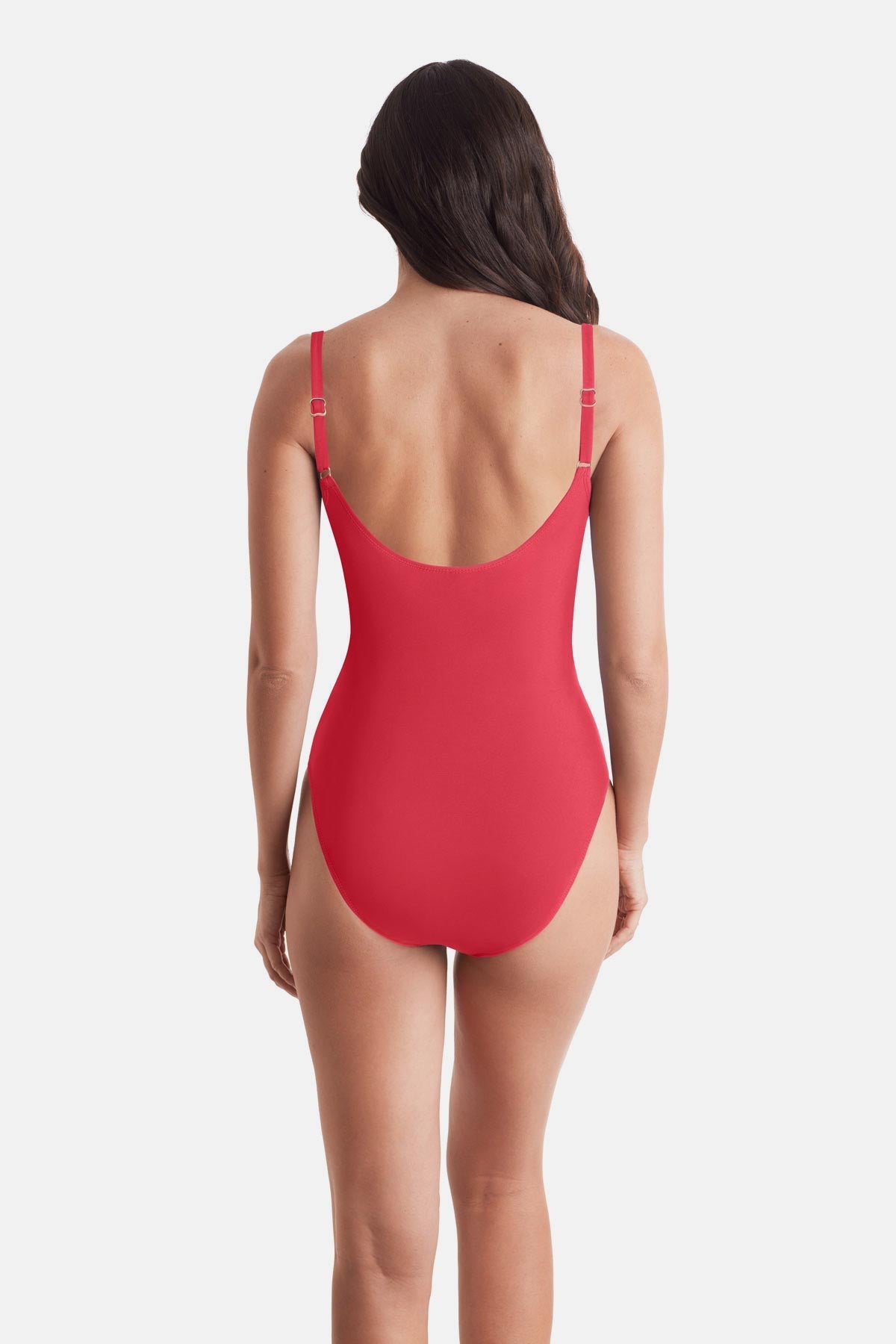 Woman turned away wearing a coral-colored one-piece swimsuit