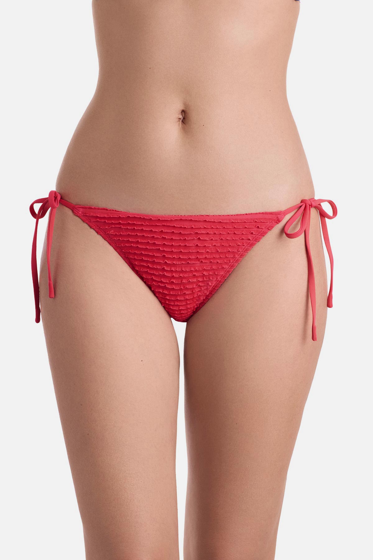 Front view of coral colored side tie swim bottoms