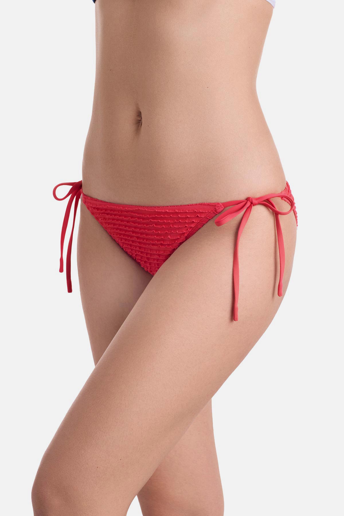 Side view of coral colored side tie swim bottoms