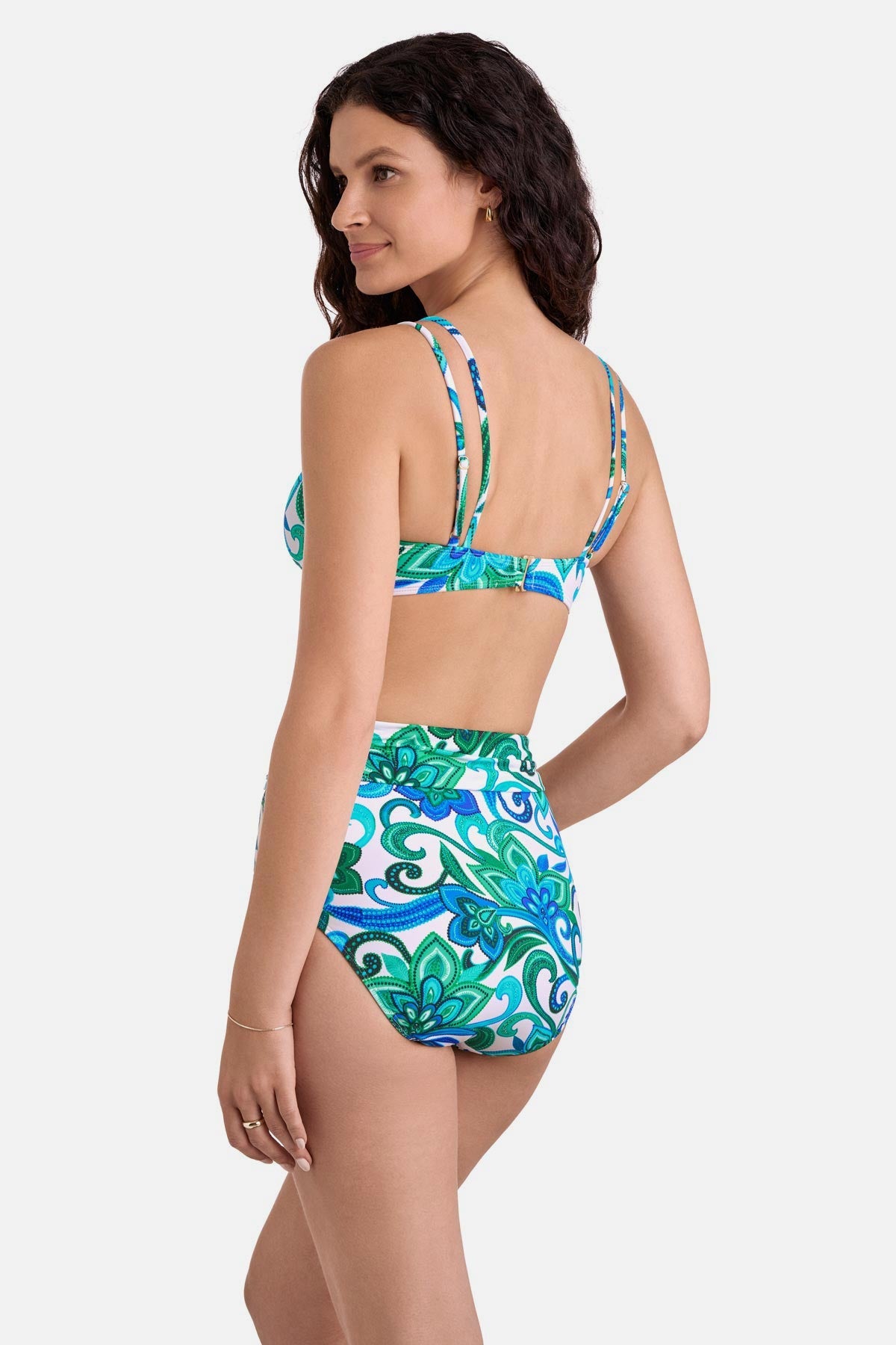 Woman turned left wearing a blue and green floral printed bikini top with matching high waisted swim bottoms