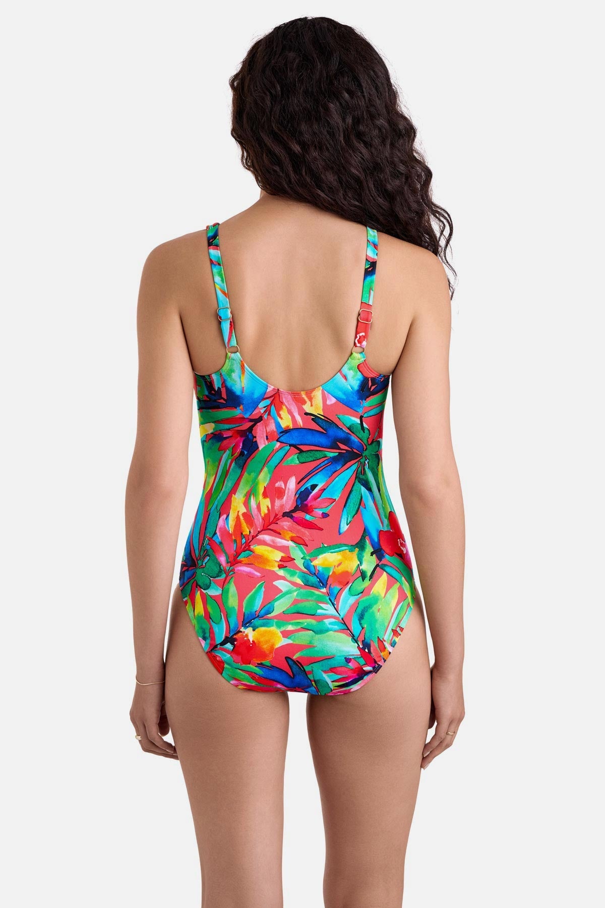 Woman turned away wearing a multicolored palm leaf printed one-piece swimsuit