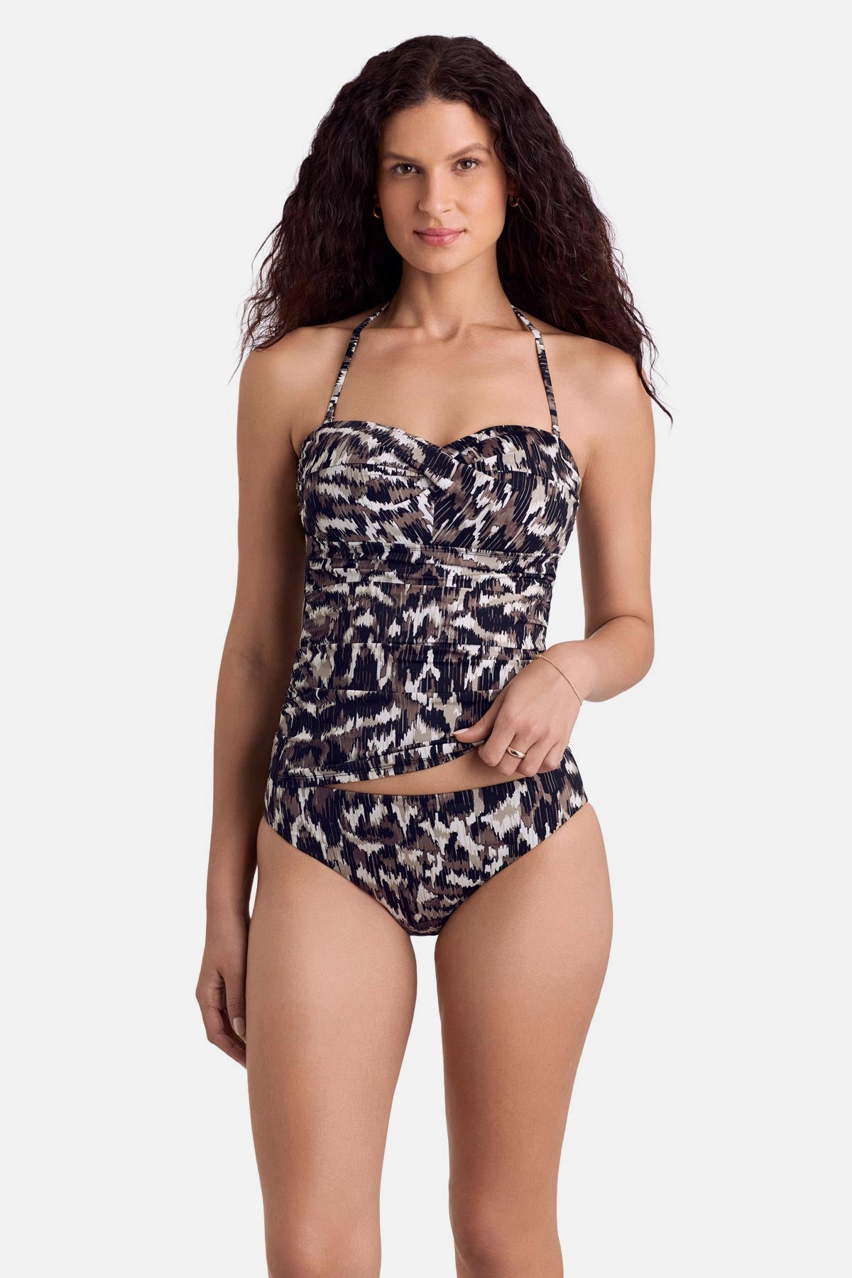 Woman wearing an animal skin print bandeau tankini top with matching swim bottoms with straps