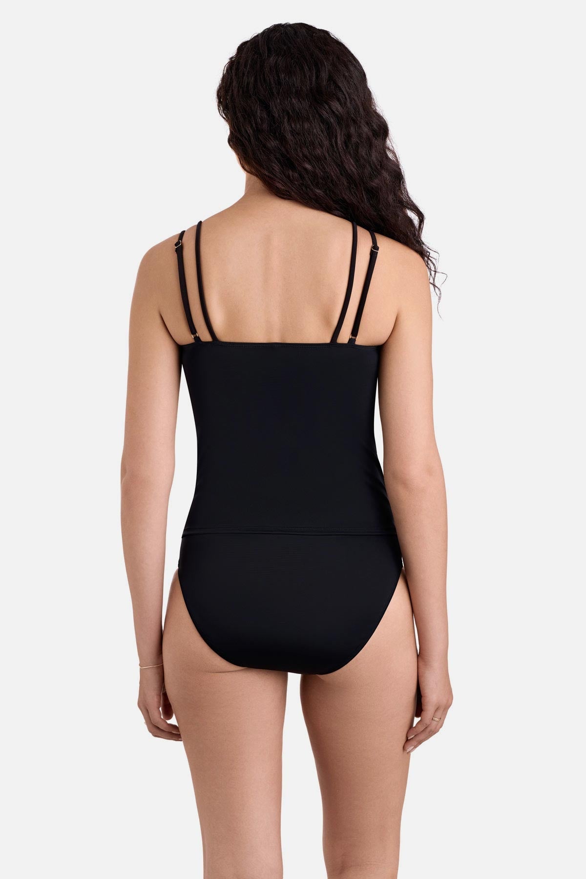 Woman turned away wearing a black tankini top with matching swim bottoms